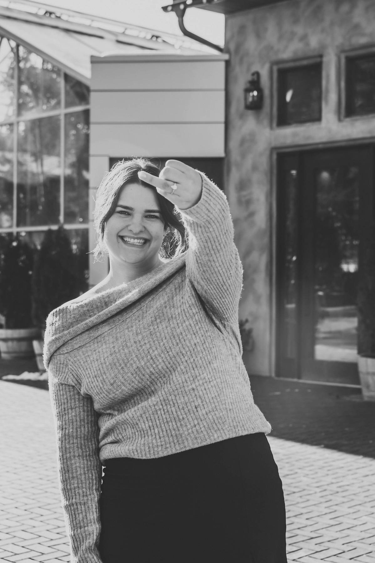 bride to be smiling with her new engagement ring during utah proposal photography session