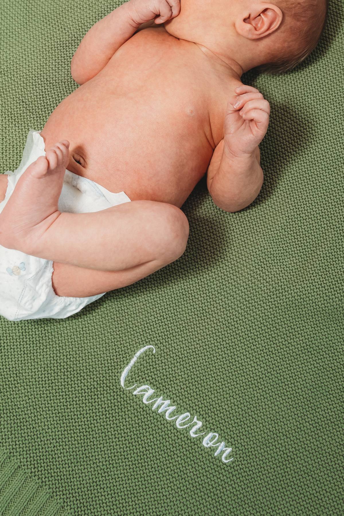 Two moms holding brand new baby during in-home newborn session, LGBTQ-friendly Utah photographer