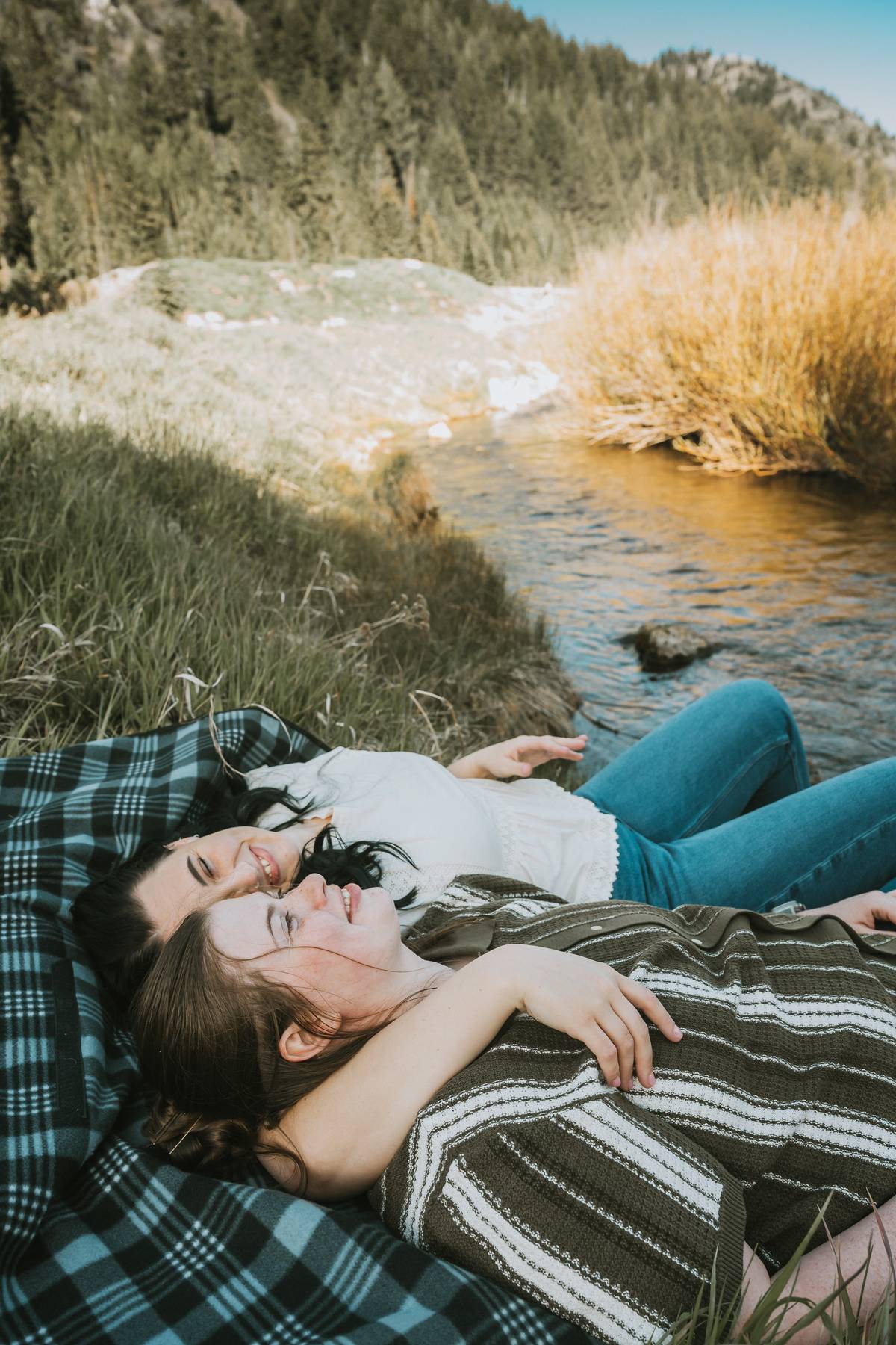 Couple laughing during Utah engagement photo shoot with kind words