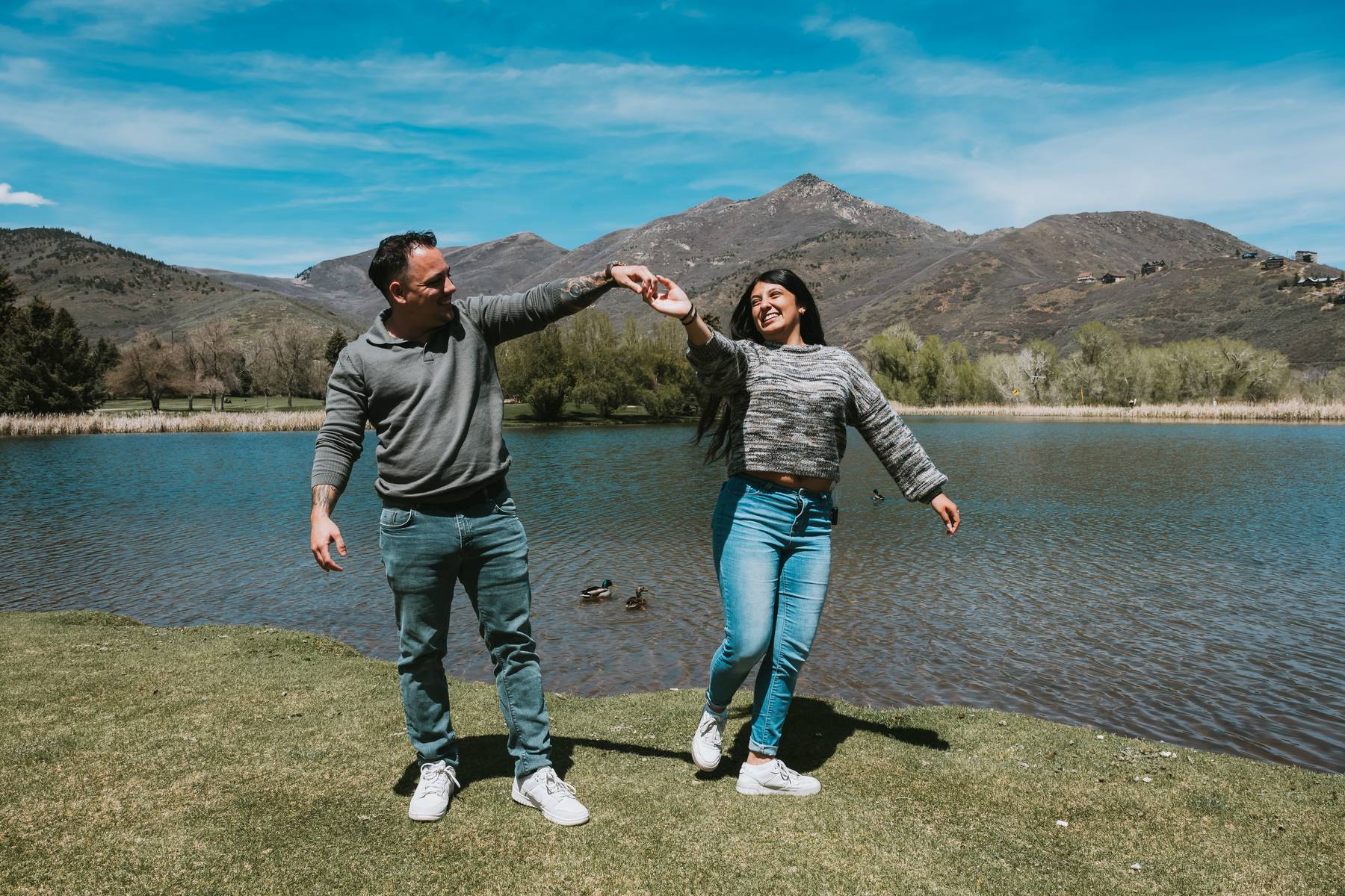 Photographer capturing authentic proposal moment on one knee at Utah lake
